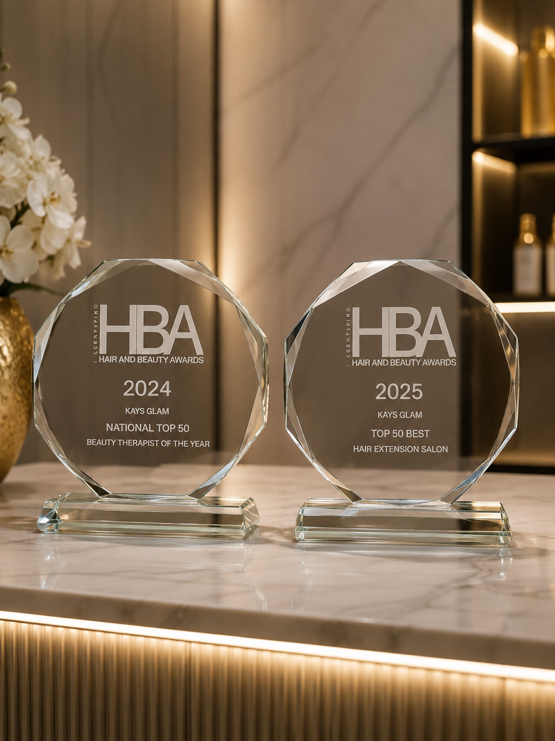 Kays Glam Hair and Beauty Awards trophies — 2024 National Top 50 Beauty Therapist of the Year and 2025 Top 50 Best Hair Extension Salon